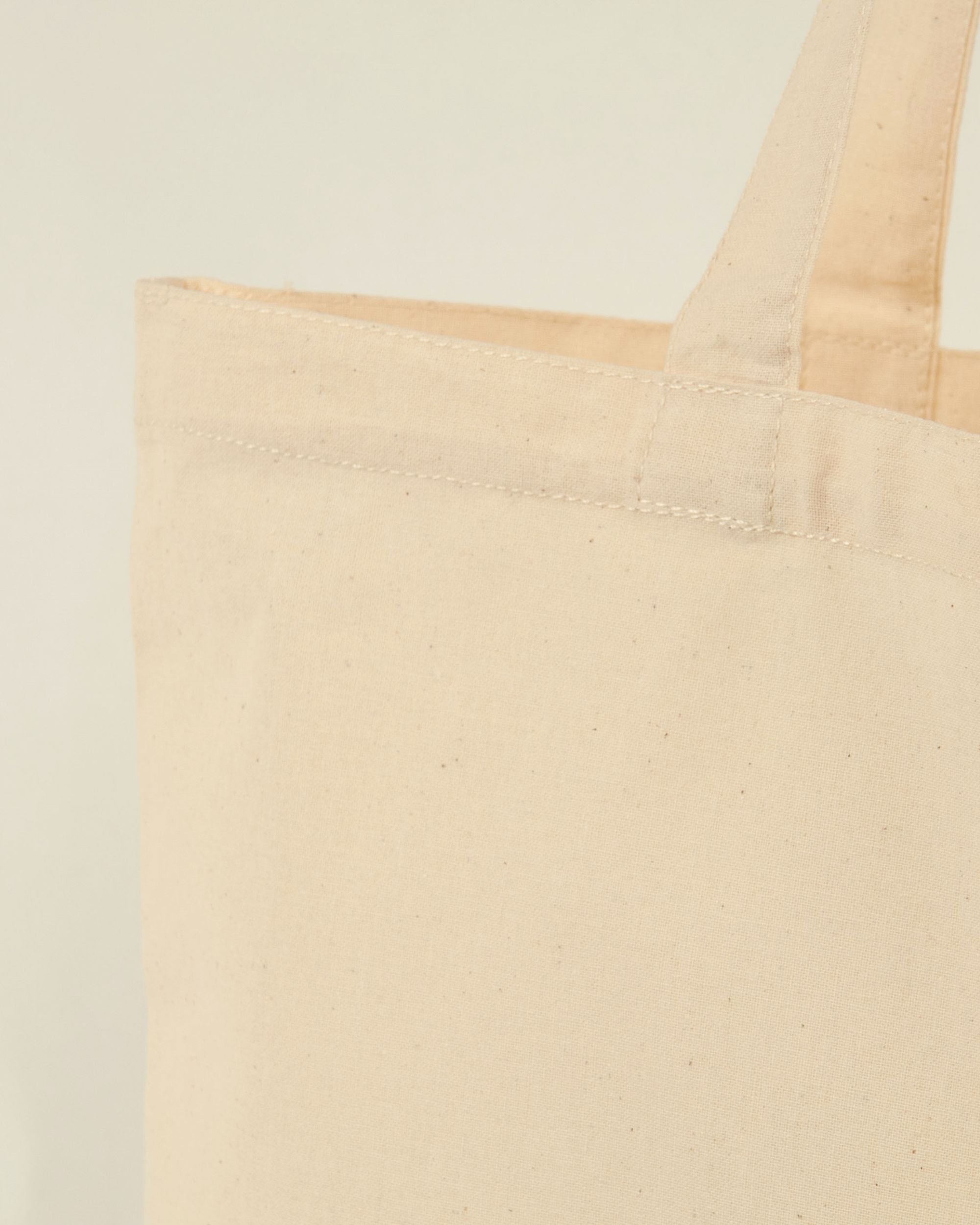 Beige tote bag details with reinforced handles