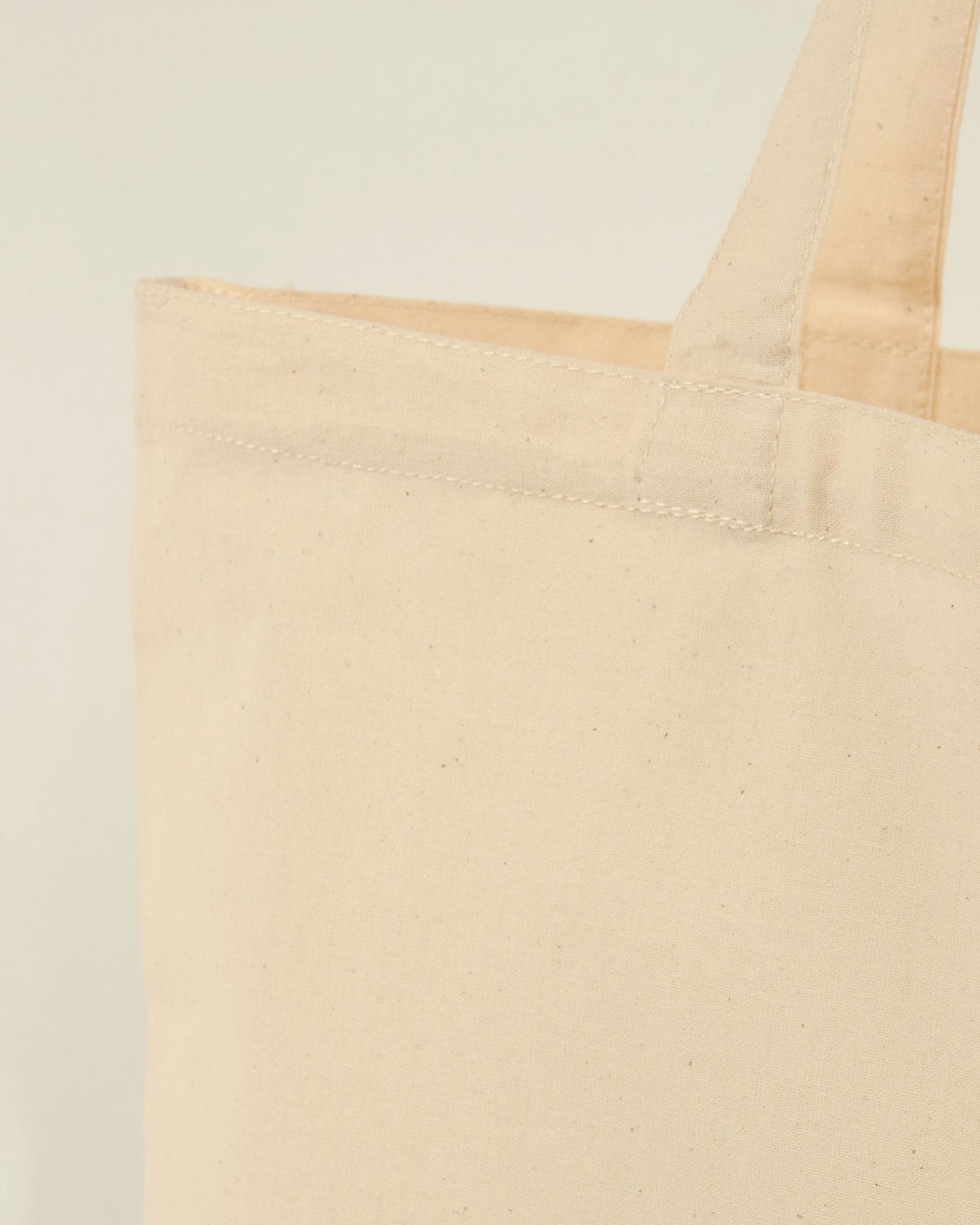 Beige tote bag details with reinforced handles