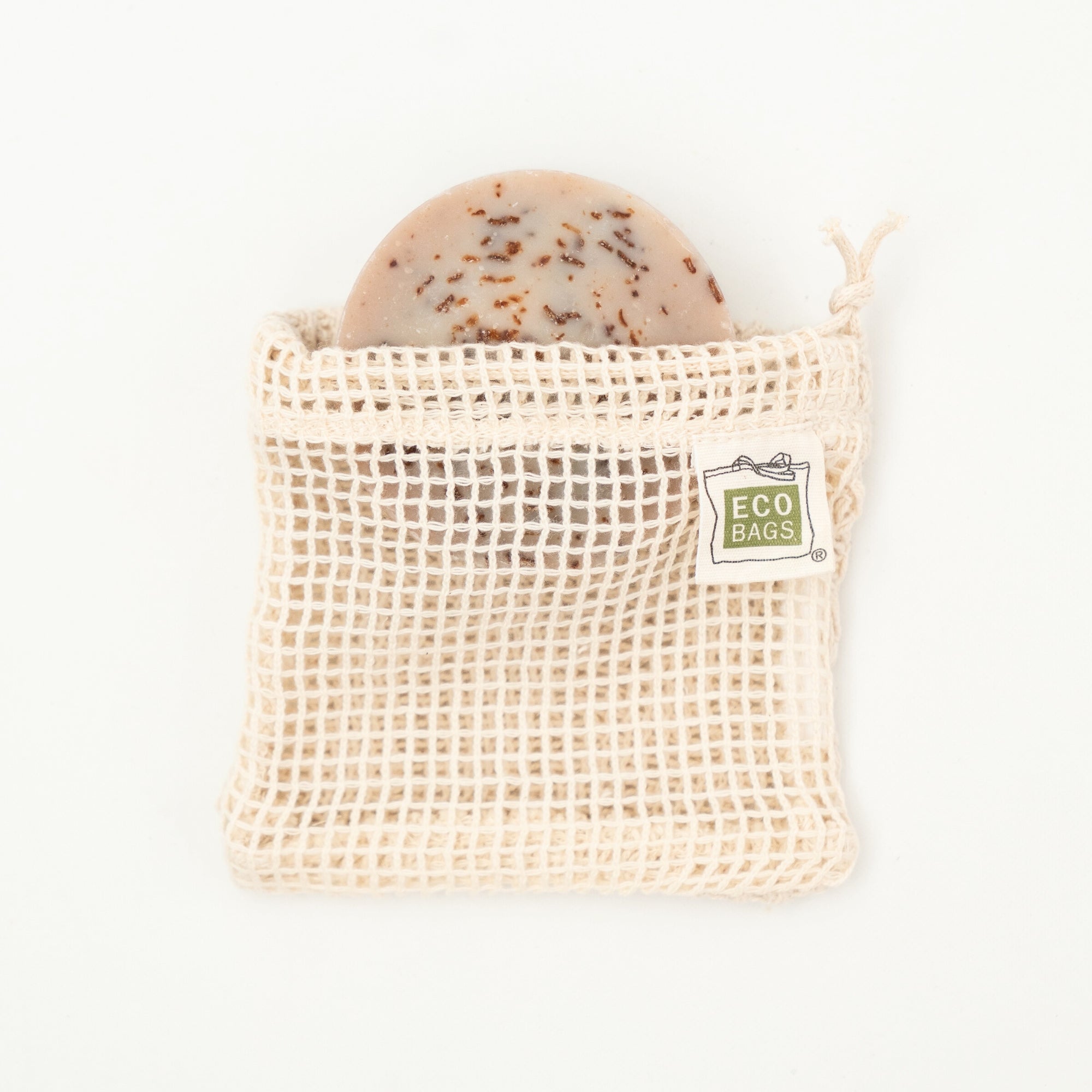 A natural colored organic cotton soap saver bag with an open mesh design, featuring a tag that reads 'ECOBAGS'.