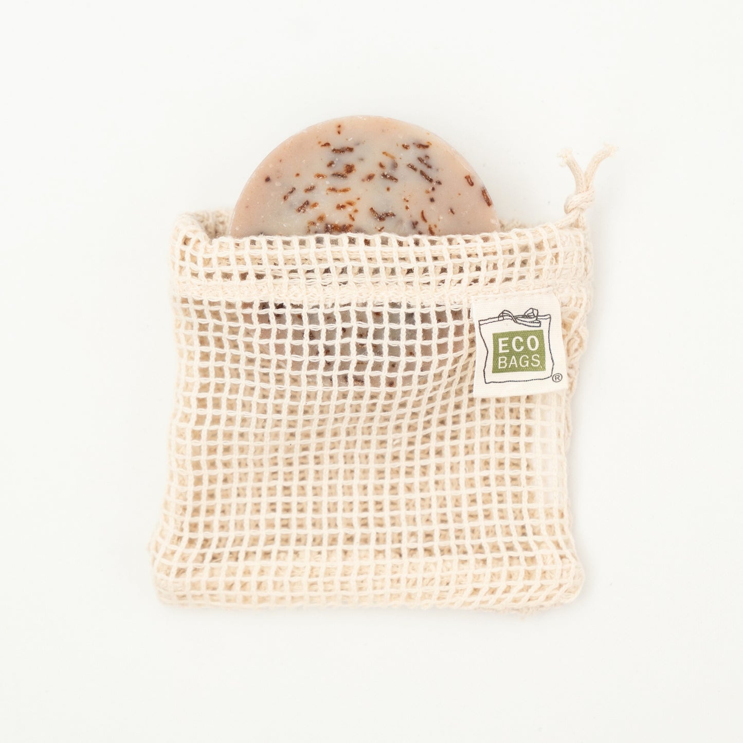 A natural colored organic cotton soap saver bag with an open mesh design, featuring a tag that reads 'ECOBAGS'.