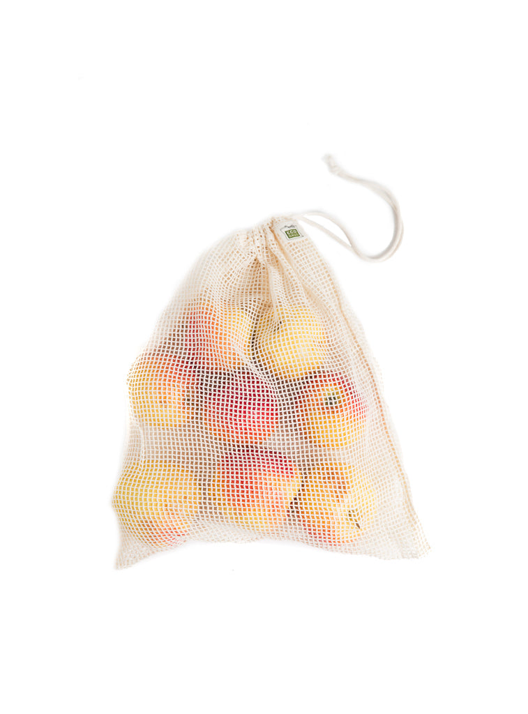 Organic cotton mesh produce bag filled with fruits, tied at the top with drawstring closure.