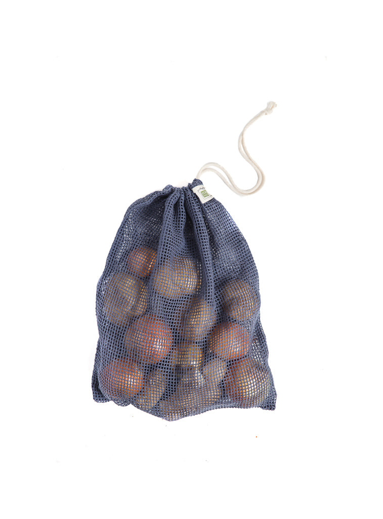 A large navy storm blue mesh organic cotton bag holds a variety of potatoes and onions